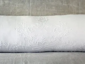 An antique linen bolster with embroidered pair of birds by Charlotte Casadéjus